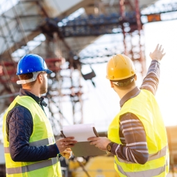 Construction site men helmet structure GETTY 586066898